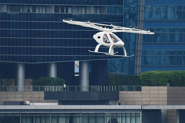 A Volocopter unmanned air taxi transport flies over Marina Bay during test flight with a safety pilot at the 26th Intelligent Transport Systems World Congress (ITSWC) in Singapore on October 22, 2019. — AFP