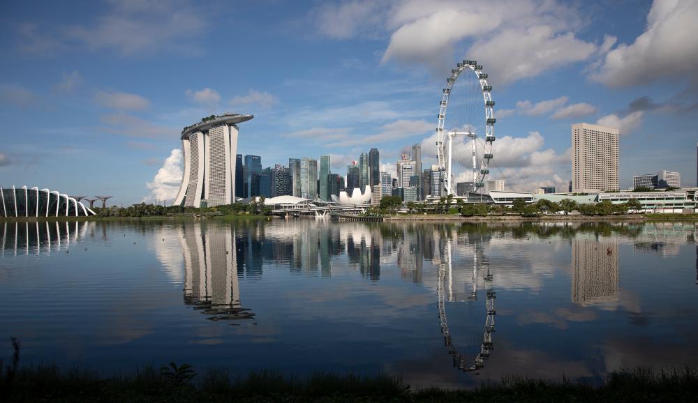 A view of Gardens by the Bay, the Marina Bay Sands, the Singapore Flyer and The Central Business district area in Singapore, 30 May 2020. - EPA
