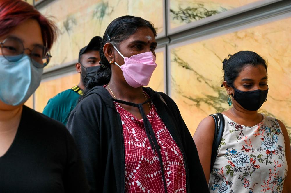Panchalai Supermaniam (C), mother of the Malaysian national Nagaenthran K. Dharmalingam sentenced to death for trafficking heroin into Singapore, arrives at the Supreme Court for the final appeal in Singapore on April 26, 2022. AFPPIX