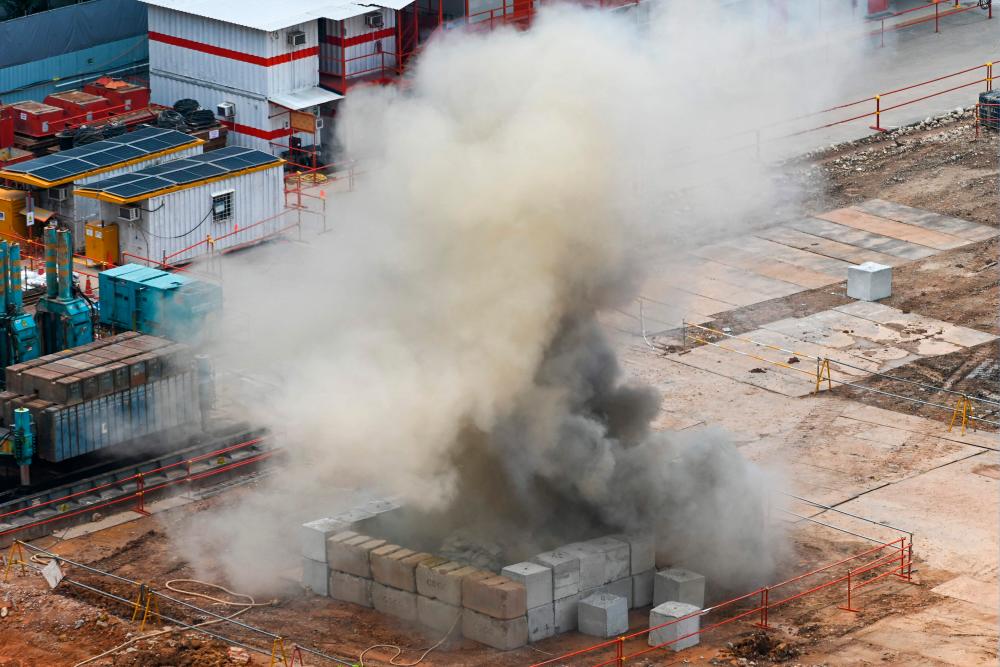 Smoke rises after a 100kg World War II-era aerial bomb is detonated at a construction site in Singapore on September 26, 2023. AFPPIX