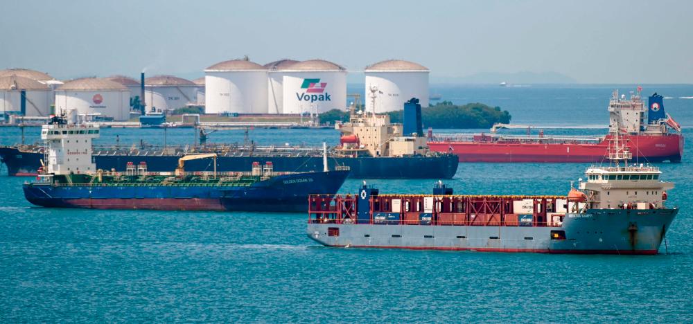 Oil tankers are pictured parked at the Western anchorage off Singapore yesterday. Oil benchmarks in recent weeks have undergone their most volatile period since mid-2020. – AFPpix