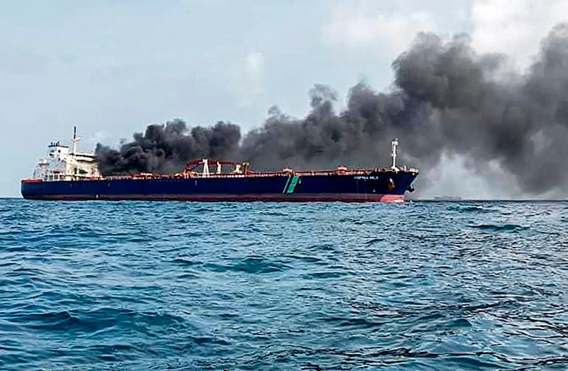 A handout photo taken and released by Malaysian Maritime Enforcement Agency on July 19, 2024 shows the Singapore-flagged tanker Hafnia Nile on fire in Tanjung Sedili, near Singapore. Singaporean authorities said two oil tankers caught fire off its coast and two crew members were airlifted to a hospital. - AFP PHOTO / Malaysian Maritime Enforcement Agency
