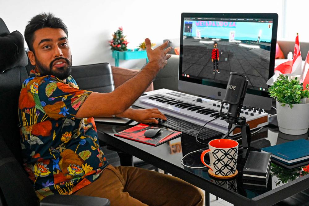 blockchain entrepreneur Vignesh Sundaresan, also known by his pseudonym MetaKovan, as he gestures to a virtual avatar of himself in his home in Singapore. Last month the programmer bought the world's most expensive NFT US artist Beeple's Everydays: The First 5,000 Days for $69.3 million, highlighting how virtual work is establishing itself as a new creative genre. –AFP