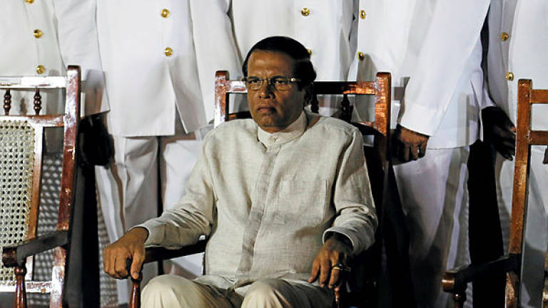 Sri Lanka’s President Maithripala Sirisena waits next to Navy officers for a group photo during a commissioning handover ceremony of the P 626 ship by US at the main port in Colombo, Sri Lanka June 6, 2019. — Reuters