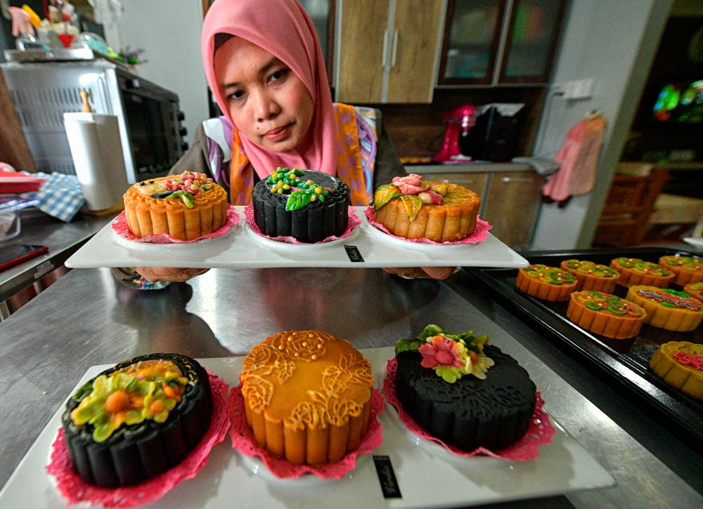 Rimba Melati Othman poses for a picture with her mooncakes. — Bernama