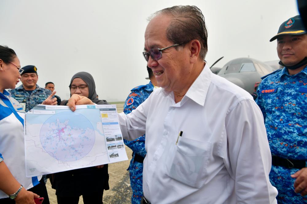 Sarawak Deputy Chief Minister Datuk Amar Douglas Uggah Embas showing a map of the cloud seeding operation. — Bernama