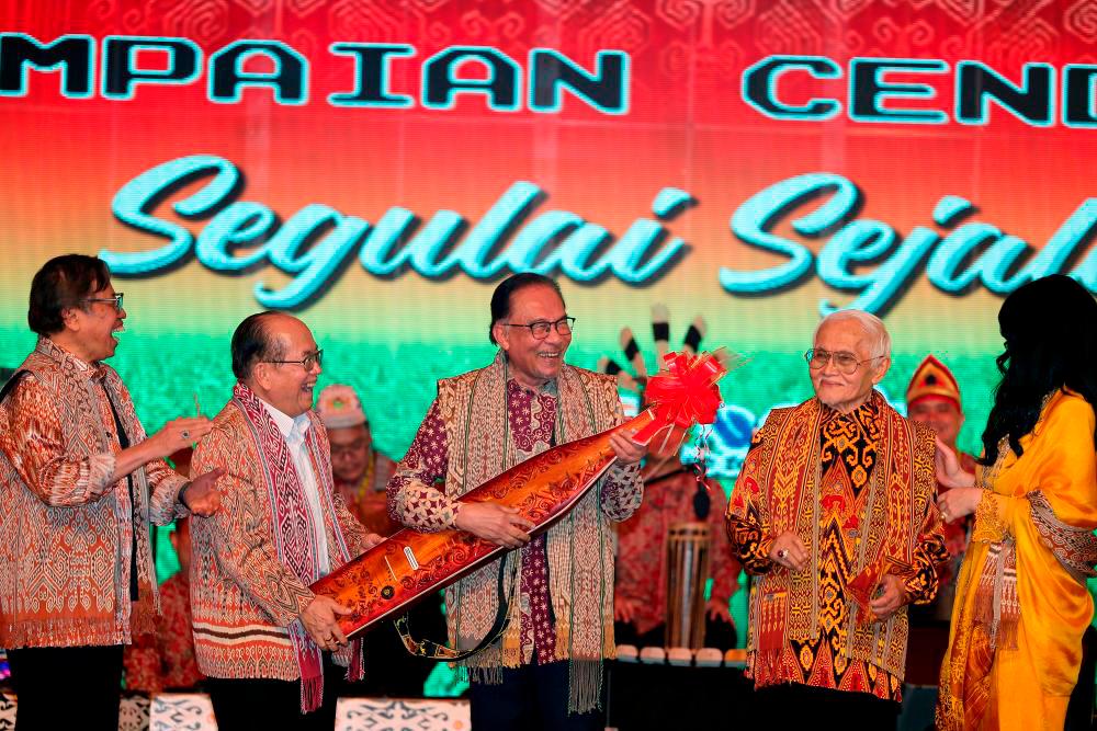 KUCHING, June 7 -- Prime Minister Datuk Seri Anwar Ibrahim (centre) tries the traditional Sarawak musical instrument ‘sape’ at the 2023 Gawai Dayak Festival at the Borneo Convention Center Kuching last week. BERNAMAPIX