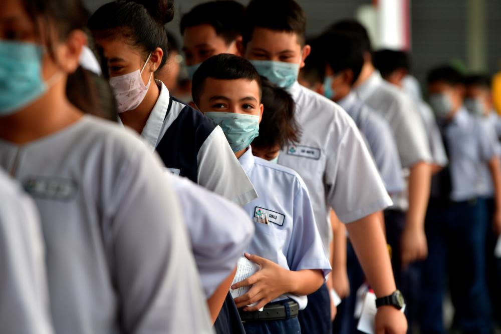Students sitting for examination wearing face masks in Sekolah Kebangsaan Jalan Ong Tiang Swee Kuching yesterday. — Bernama