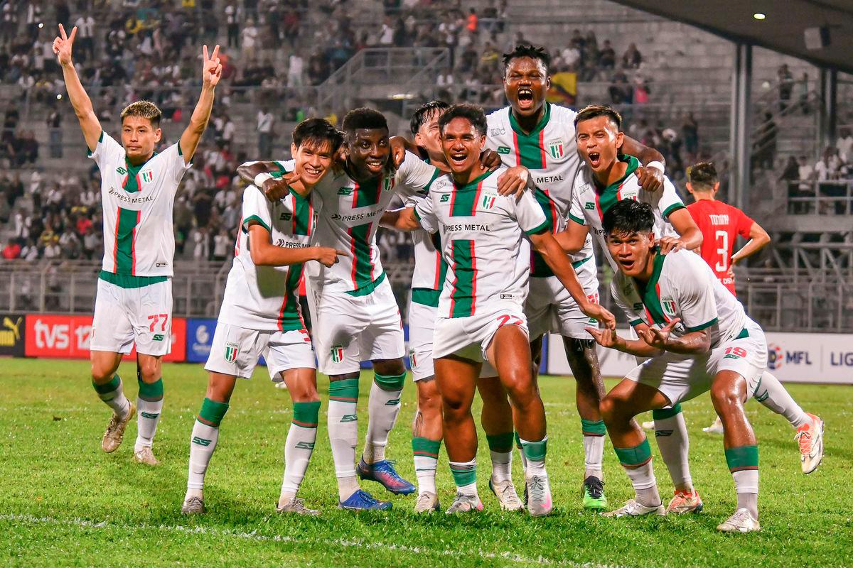 The action of Kuching City FC players after scoring a goal in the final minutes of the FA Cup match at the State Stadium last night. - BERNAMA