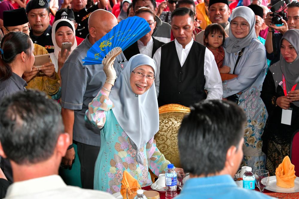 Deputy Prime Minister Datuk Seri Dr Wan Azizah Wan Ismail, who is also Women, Family and Community Development Minister, welcomes the audience at the Aidilfitri celebration at the Matang Mall compound today. - Bernama