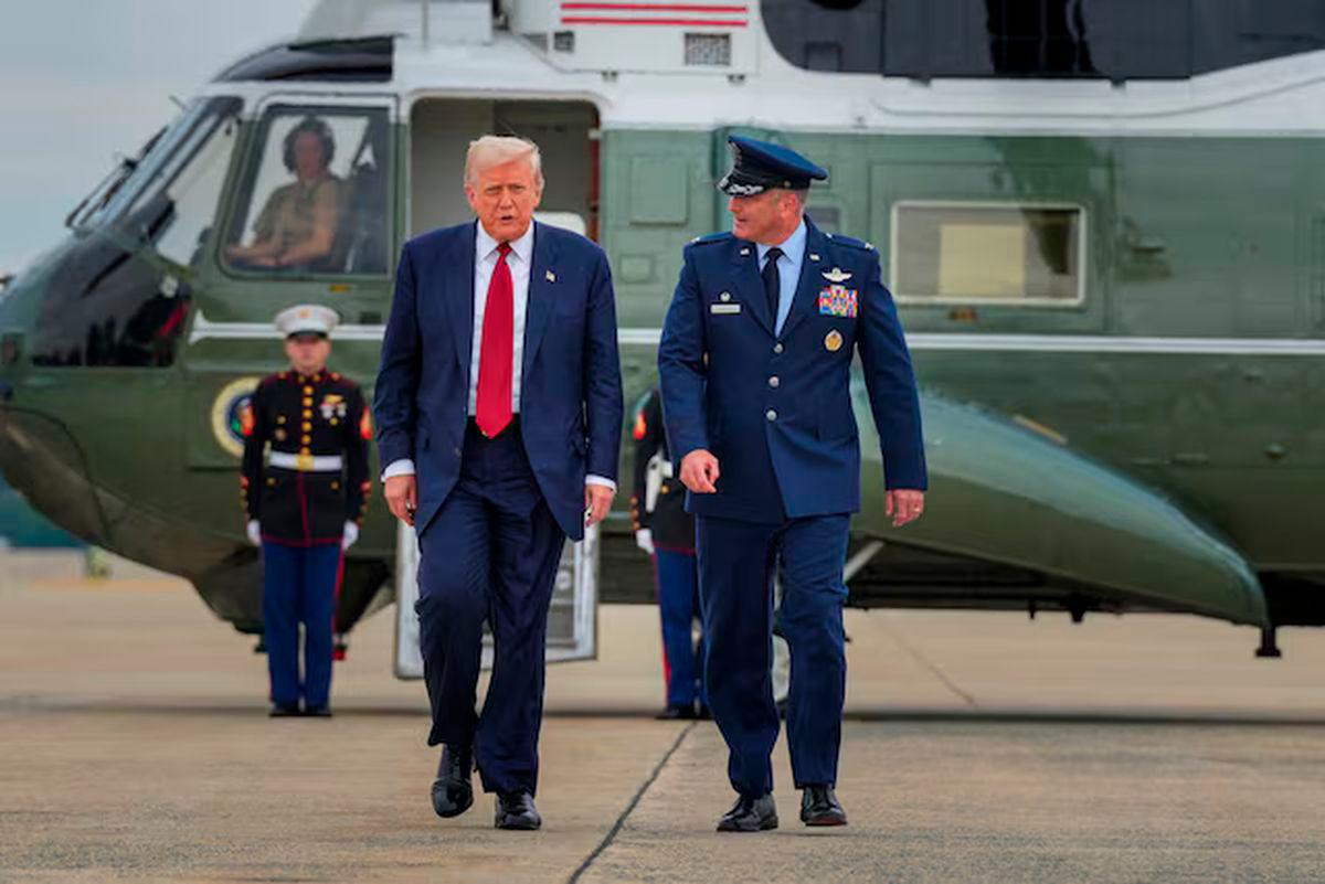 U.S. President Donald Trump walks with Col. Christopher Robinson 89th Airlift Commander after stepping off Marine One at Joint Base Andrews, Maryland, U.S., August 1, 2025. REUTERS/Ken Cedeno