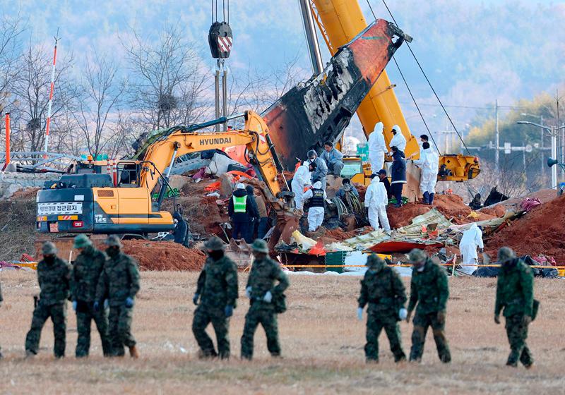 Teams salvage the second engine of the Jeju Air Boeing 737-800 aircraft which crashed and burst into flames at Muan International Airport, in Muan on January 4, 2025. South Korean investigators said on January 4 they were close to finalising the transcript of the cockpit voice recorder from a fatal plane crash that left 179 people dead last week. - YONHAP / AFP