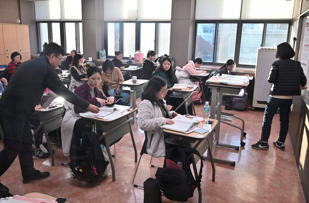 Students prepare to sit the annual college entrance exam in a classroom at a high School in Seoul on Nov 14. — AFP