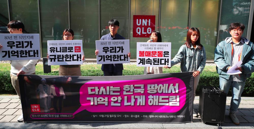 South Korean protesters hold a rally denouncing an advertisement for Uniqlo outside a Uniqlo shop in Seoul on Oct 21, 2019. — AFP