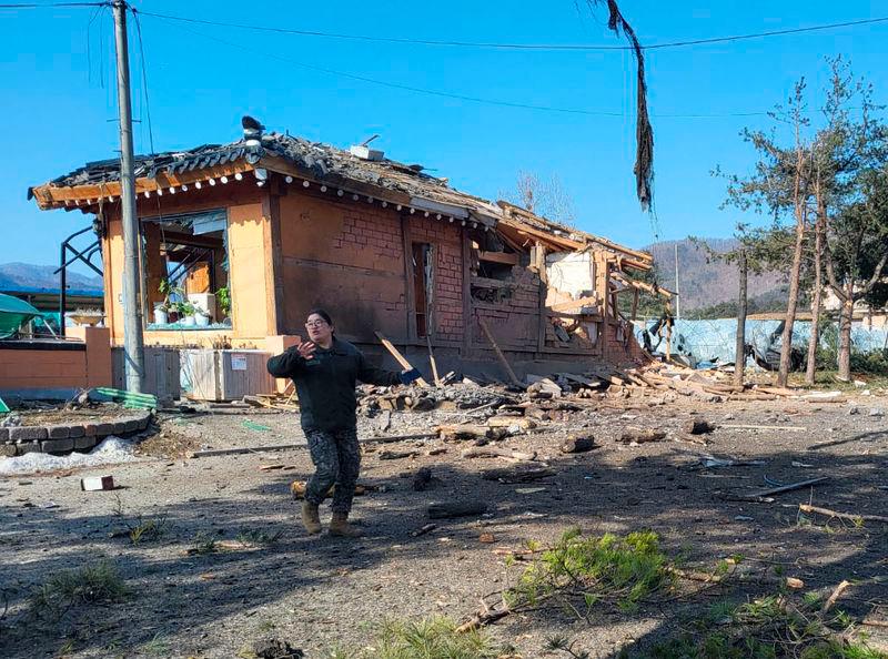 A South Korean soldier gestures near a bomb accident site outside a military live-fire training range in Pocheon on March 6, 2025. South Korea’s Air Force said on March 6, that one of its fighter jets had accidentally dropped eight bombs in the wrong place during a training exercise, resulting in civilians being injured. AFPpix