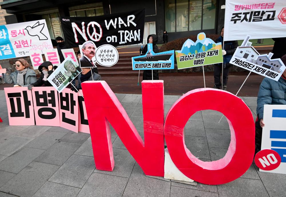 South Korean activists hold placards reading No dispatch to Hormuz! during a rally denouncing the government's decision to send troops to the Strait of Hormuz, near the US embassy in Seoul on Jan 21. — AFP