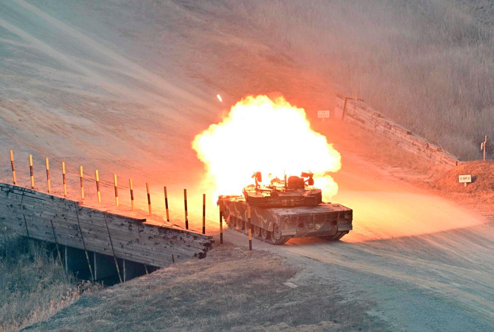 A South Korean K1A1 tank fires during a Warrior Shield live fire exercise at a military training field in Pocheon on March 22, 2023, as part of the Freedom Shield joint military exercise. South Korea and the United States kicked off the Freedom Shield joint military exercise, their largest drills in five years, which will run for 10 days from March 13, 2023 as part of the allies drive to counter North Korea's growing threats. AFPPIX