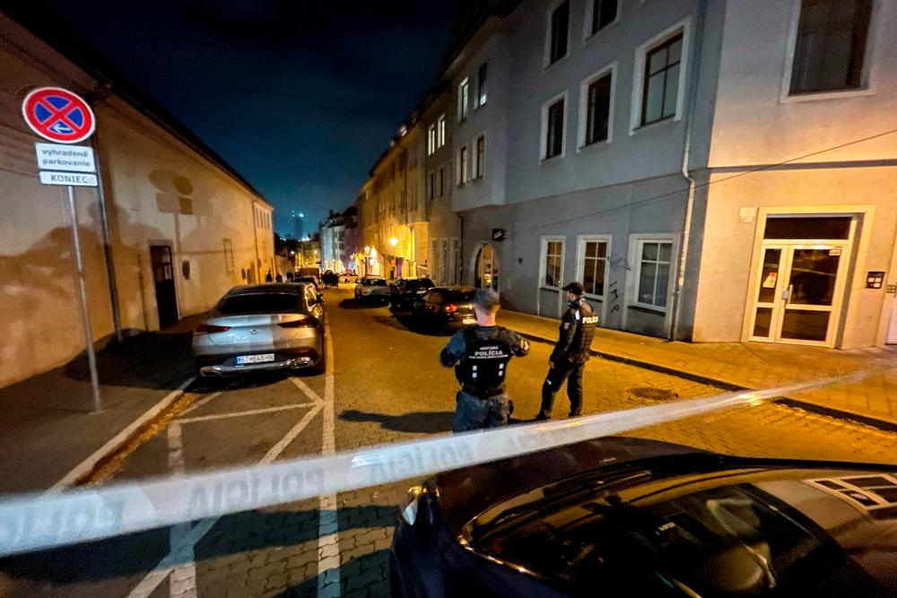 This picture taken on October 12, shows Police patroling tne cordoned off Zamocka street in downtown Bratislava, Slovakia following a shooting. AFPPIX