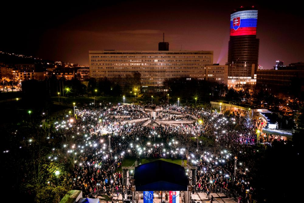 People gather for the protest For a decent Slovakia on Nov 17, 2019 in Bratislava, Slovakia, as part of the commemorations of the peaceful Velvet Revolution that toppled the Communist regime in former Czechoslovakia 30 years ago. — AFP