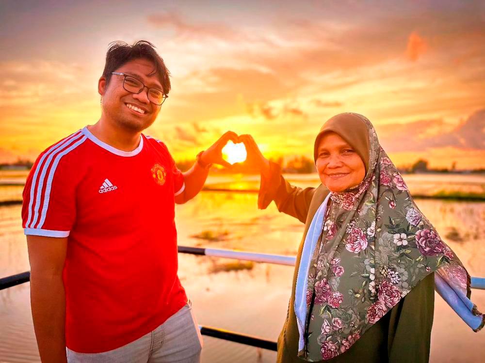 $!First prize winner Mohd Niza Othman (left) and his mother embracing the sun. – PIC FROM INSTAGRAM @NIZAOSOLARI