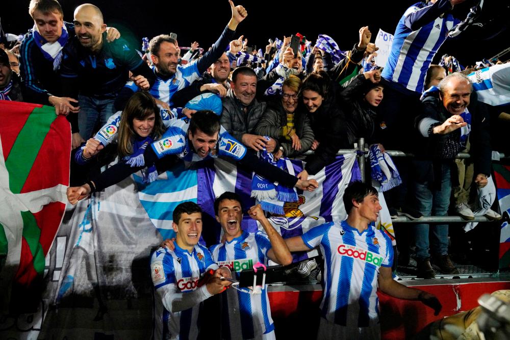 Real Sociedad players celebrate after the match. — Reuters