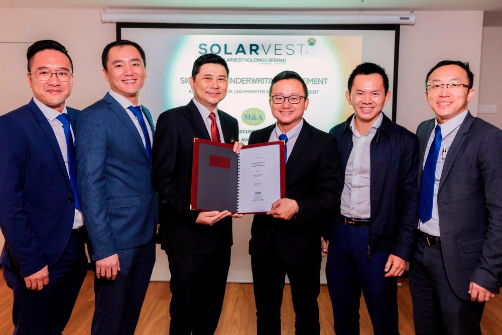Atlantic Blue Holdings Sdn Bhd director Tan Paw Boon (from left), Solarvest director Edmund Tan Chyi Boon, M&amp;A Securities Sdn Bhd managing director Datuk Bill Tan, Solarvest managing director Lim Chin Siu, director Chiau Haw Choon and Chong at the signing ceremony today.