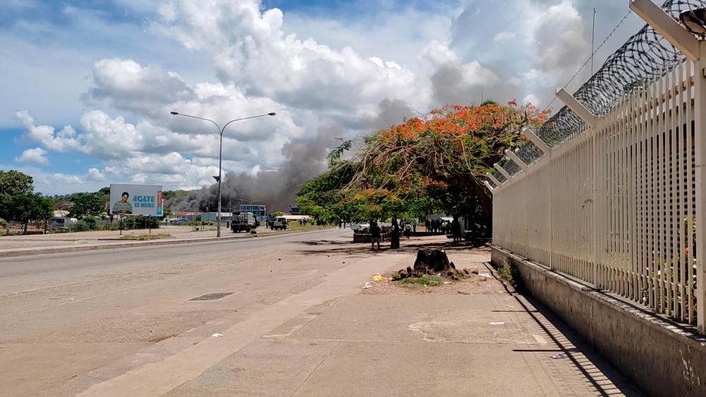 Smoke is seen after buildings were set on fire in Chinatown, as Solomon Islanders defied a government-imposed lockdown and protested in the capital, in Honiara, Solomon Islands November 25, 2021, in this still image taken from video provided on social media. Georgina Kekea/via REUTERSpix