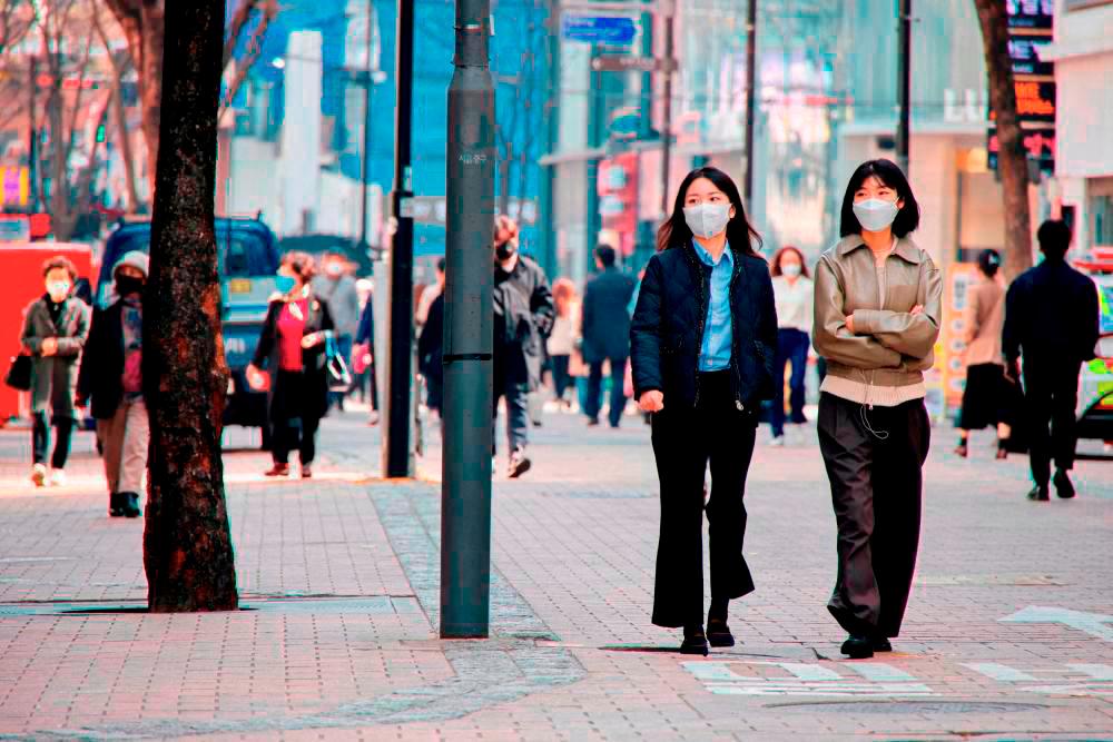 File photo: Women wearing masks walk in a shopping district amid the Covid-19 pandemic in Seoul, South Korea, March 16, 2022. REUTERSpix