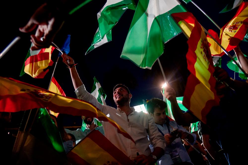 Supporters of Partido Popular (PP) candidate for the Andalusian regional election Juanma Moreno celebrate during a meeting following the Andalusian regional elections, in Seville on June 19, 2022. AFPpix