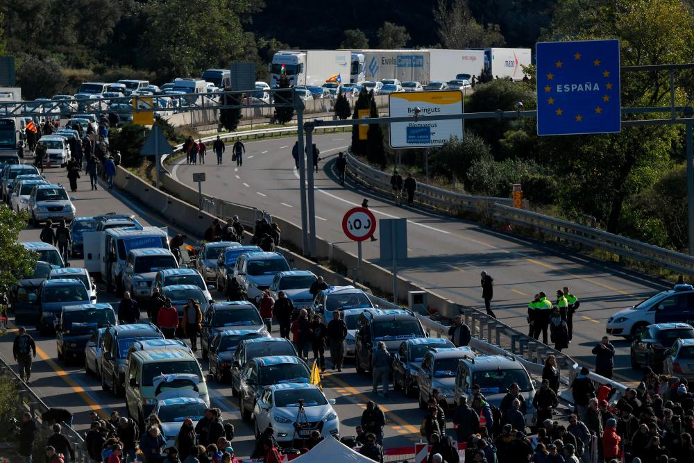 Protesters block the AP-7 highway at the Spanish-French border in La Jonquera, northern Spain, on Nov 11 during an action called by Tsunami Democratic movement for civil disobedience actions. — AFP