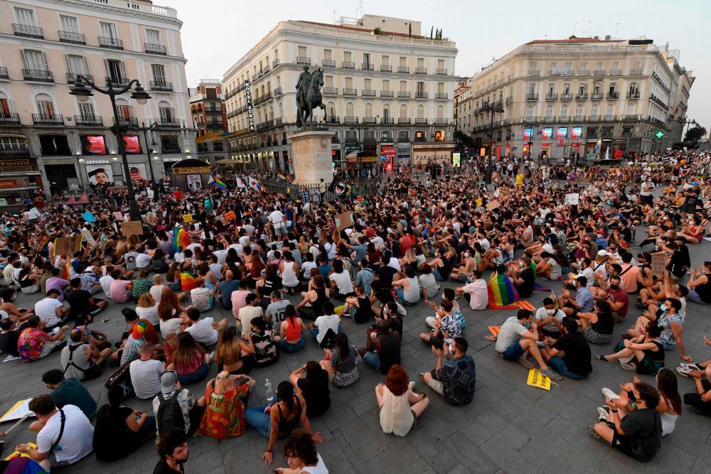 People take part in a demonstration to protest against LGTBI-phobia at the Puerta del Sol square in Madrid on July 11, 2021. The killing of Samuel Luiz on July 3, 2021 in Corunna, in a suspected homophobic attack, has sparked nationwide protests to demand better protection for gay people. – AFP