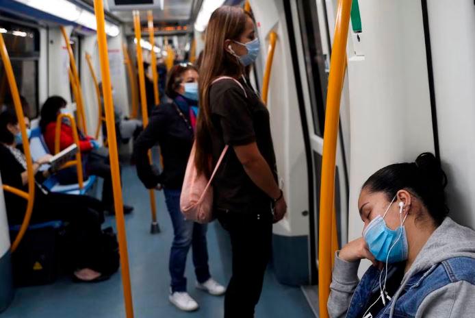 FILE PHOTO: A commuter wearing a protective mask sleeps inside a metro coach, on the first day mask usage is mandatory in public transport, amid the coronavirus disease (Covid-19) outbreak in Madrid, Spain, May 4, 2020. REUTERSPIX
