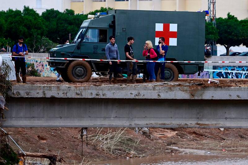 A military vehicle goes past people in Paiporta, in the region of Valencia - AFPpix