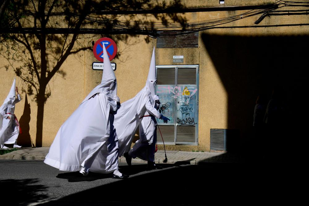 Penitents walk down a street during the Holy Week’s Palm Sunday celebration in Seville on April 2, 2023. AFPPIX