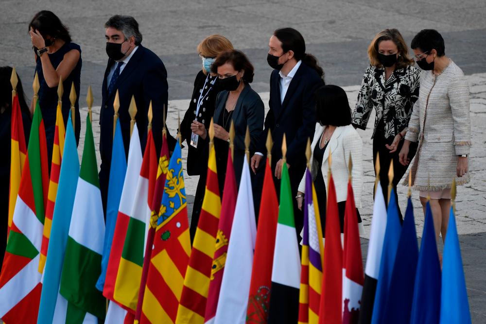 Ministers of the Spanish Government arrive to attend a state ceremony to honour the 28,400 victims of the coronavirus crisis as well as those public servants who have been fighting on the front line against the pandemic in Spain, on July 16, 2020, at the Royal Palace in Madrid. — AFP