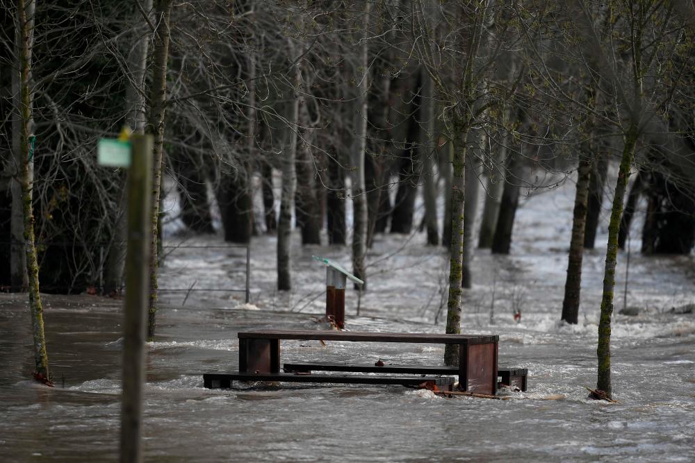 A flooded picnic area is pictured near the Ter river in Angles, near Girona, on Jan 23, as storm Gloria batters Spanish eastern coast. — AFP