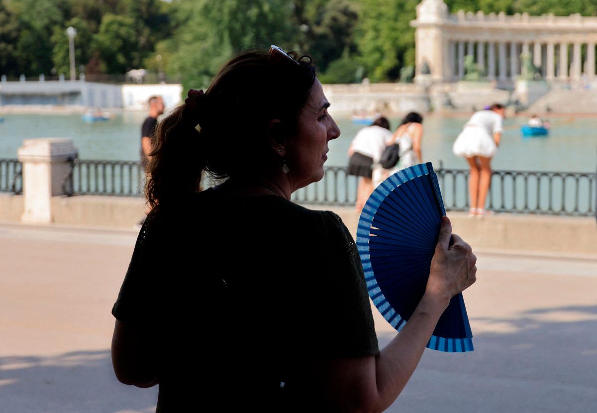A woman uses a hand fan in a park during the first heatwave of the summer in Madrid, on June 28, 2025. Starting June 28, 2025 southern Europe will once again face extreme temperatures exceeding 40°C. - AFPpix