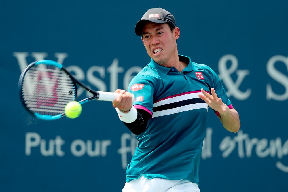 Kei Nishikori of Japan returns a shot to Yoshihito Nishioka of Japan during the Western &amp; Southern Open at Lindner Family Tennis Center on August 14, 2019 in Mason, Ohio. — AFP