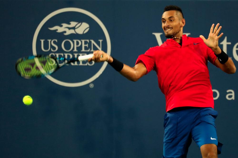 MASON, OH - AUGUST 19: Nick Kyrgios of Australia returns a shot to David Ferrer of Spain during Day 8 of the Western and Southern Open at the Linder Family Tennis Center on August 19, 2017 in Mason, Ohio. - AFPPIX