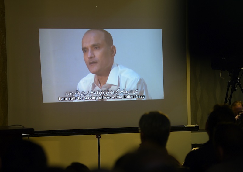 This file photo taken March 29, 2016 shows Pakistani journalists watching a video showing Indian national Kulbhushan Jhadav, arrested on suspicion of spying, during a press conference in Islamabad. — AFP