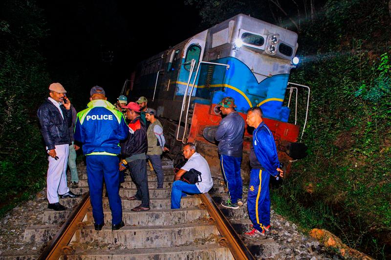 Police and railway personnel examine a derailed train at Habarana in eastern Sri Lanka on February 20, 2025, which killed six elephants. A Sri Lankan express train was travelling near a wildlife reserve at Habarana, some 180 kilometres (110 miles) east of the capital Colombo, when it hit a herd of elephants crossing the line before dawn. - AFPpix