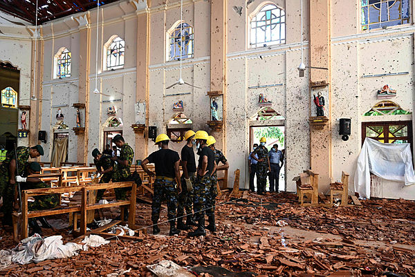 Security personnel inspect the interior of St Sebastian’s Church in Negombo on April 22, 2019, a day after the church was hit in series of bomb blasts targeting churches and luxury hotels in Sri Lanka. — AFP
