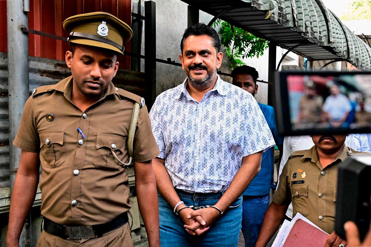 Police escort Sri Lanka’s former Agriculture Minister Shasheendra Rajapaksa (C) to a prison in Colombo on August 6, 2025. Sri Lanka’s anti-corruption authorities arrested a member of the once-powerful Rajapaksa family, a nephew of two presidents, Mahinda and Gotabaya on August 6, accusing him of illegally claiming reparations for property loss when his uncle was toppled as president three years ago. - Ishara S. KODIKARA / AFP