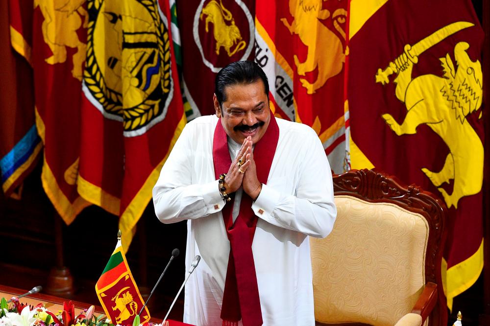 Sri Lanka's new Prime Minister Mahinda Rajapaksa gestures upon his arrival for a ministerial swearing-in ceremony in Colombo on Nov 22, 2019. — AFP