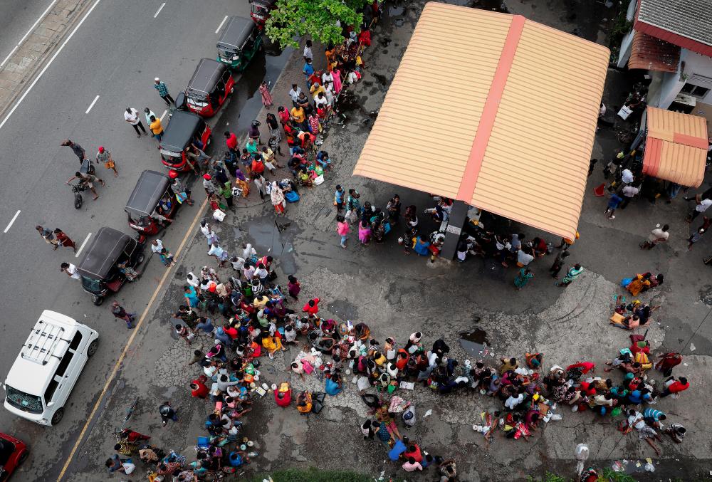 File photo: People wait in a queue to buy kerosene at a fuel station, amid the country's economic crisis in Colombo, Sri Lanka, May 18, 2022. REUTERSpix