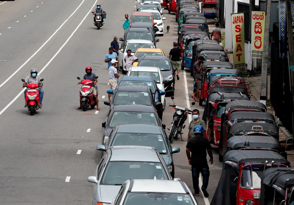 Drivers in their vehicles wait in a queue to buy petrol at a fuel station, amid the country's economic crisis in Colombo, Sri Lanka, May 16, 2022. REUTERSpix