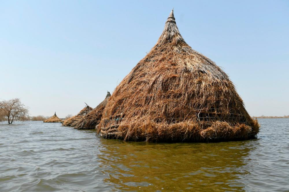 A general view of traditional houses known as “tukul” submerged in water in Tong village in Bentiu on February 7, 2023. AFPPIX