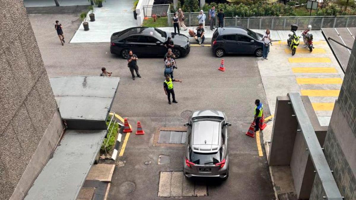 The family of the Form 4 schoolgirl who was stabbed to death this morning leaving the forensic department at Universiti Malaya Medical Centre, where her body was taken for post-mortem, in a car today. – Photo by THE SUN