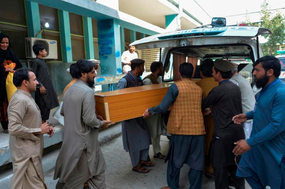Relatives carry the coffin of a victim, who was killed in a stampede, outside a mortuary in Jalalabad, today. — AFP