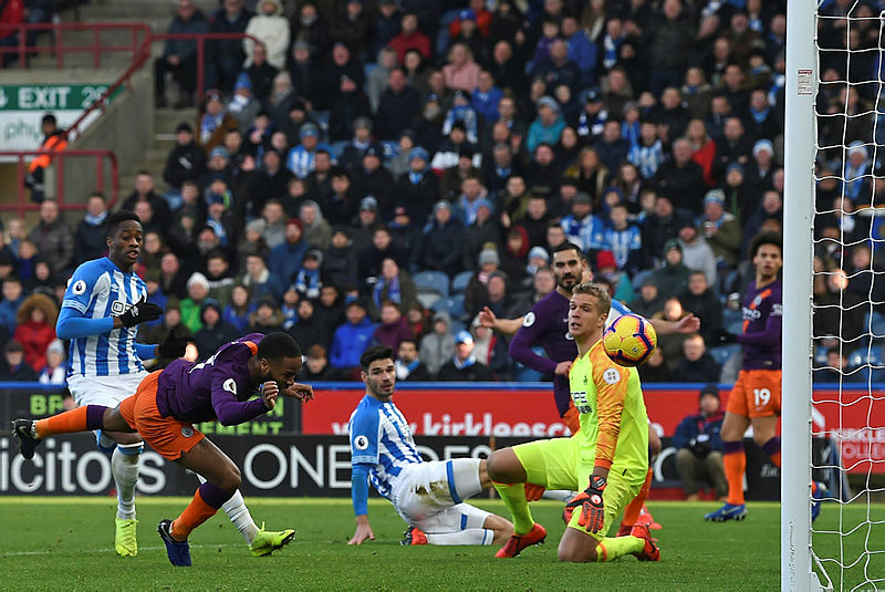 Raheem Sterling (2nd L) heads home City’s second goal during against Huddersfield the John Smith’s stadium ,on Jan 20, 2019. — AFP